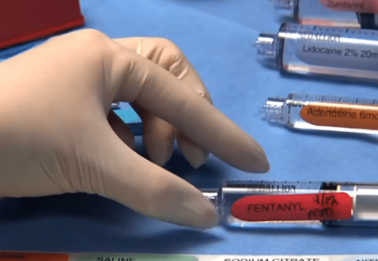 Doctor handing disposable waste syringes