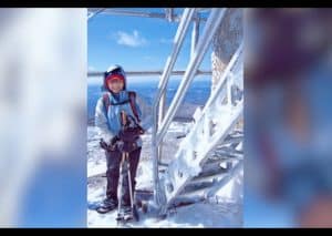 Andrea Peterson at the North Pole, standing next to a staircase covered in snow & ice