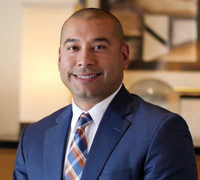 Photo showing Raul Parra, CFO of Merit Medical, sitting on a table