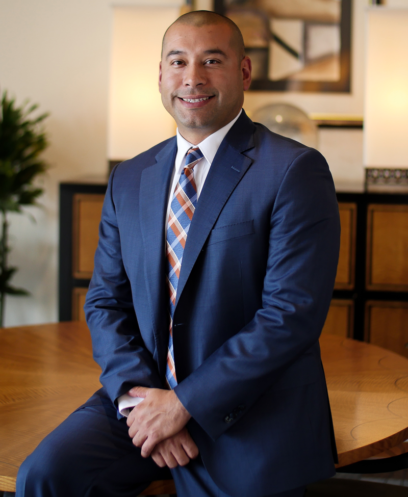 Photo showing Raul Parra, CFO of Merit Medical, sitting on a table