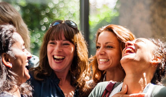 A group of females laughing and talking together