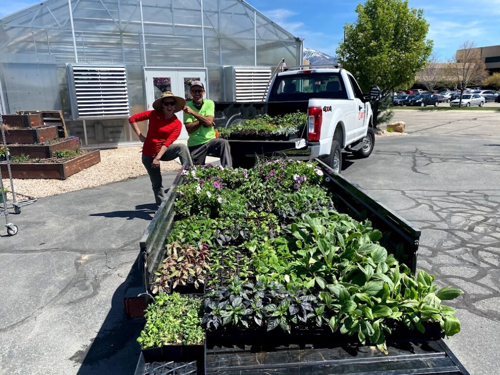 Image showing a white truck hauling a trailer of flowers and plant seedlings