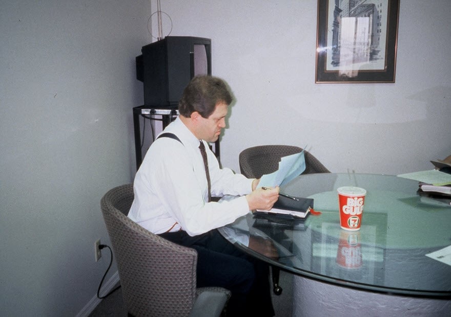 Fred Lampropoulos working at a table in the first Merit Medical headquarters in 1987