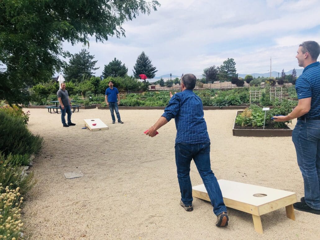 Picture of Merit employees playing cornhole