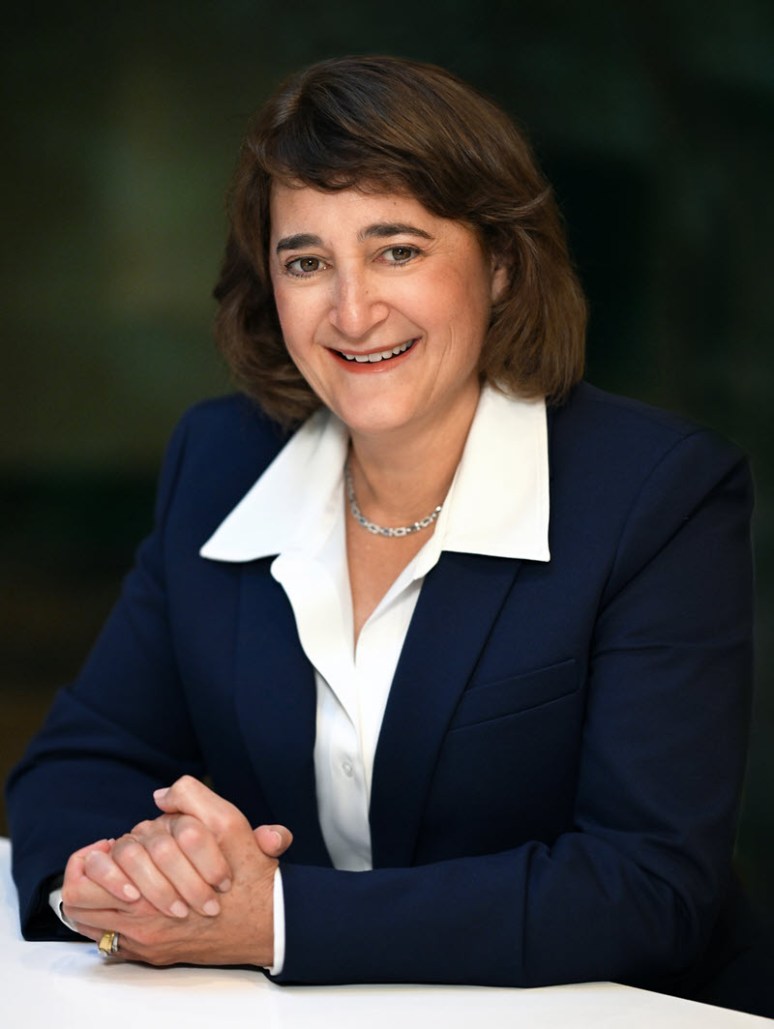 Martha Aronson, seated at a table, President and CEO Appointee, effective Oct 3, 2025
