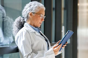 Female physician reviewing a ipad screen